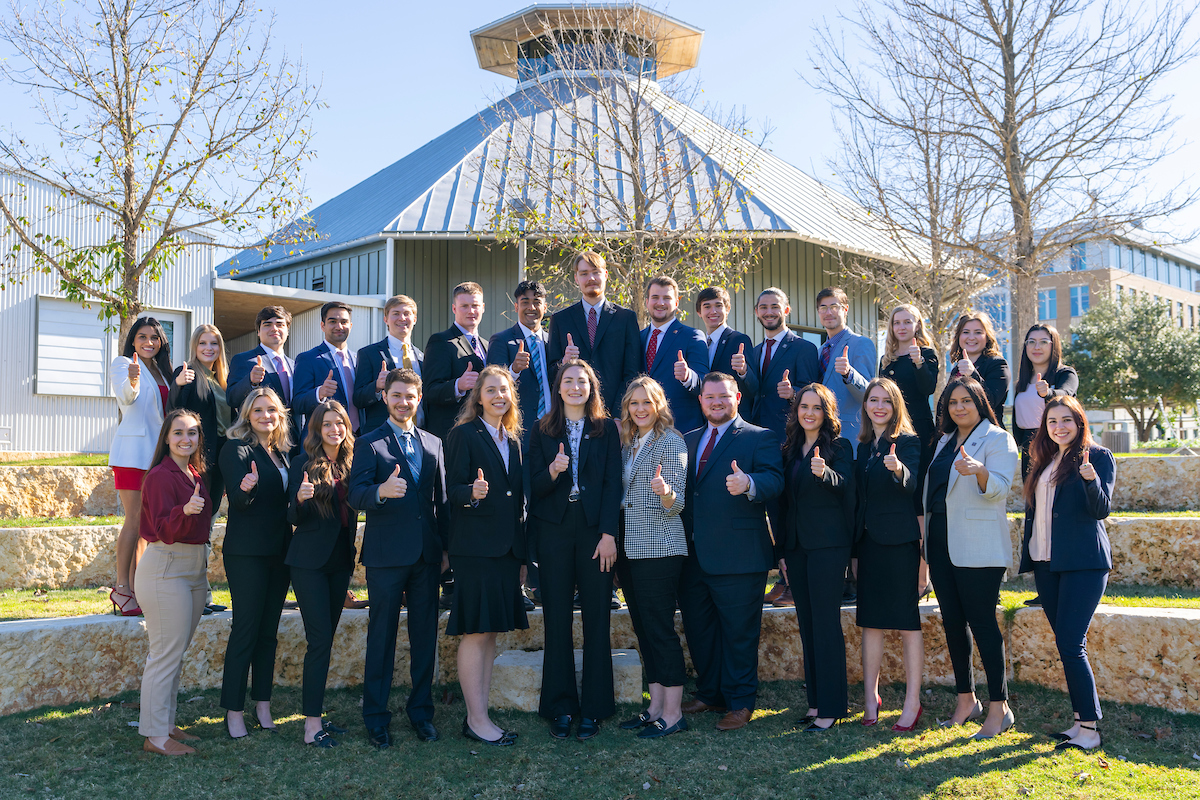 PPIP Interns standing together with business formal attire and their thumbs up